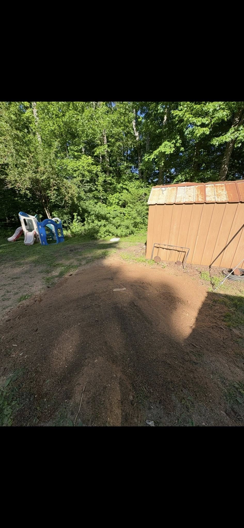 Backyard cleared near a children's playset